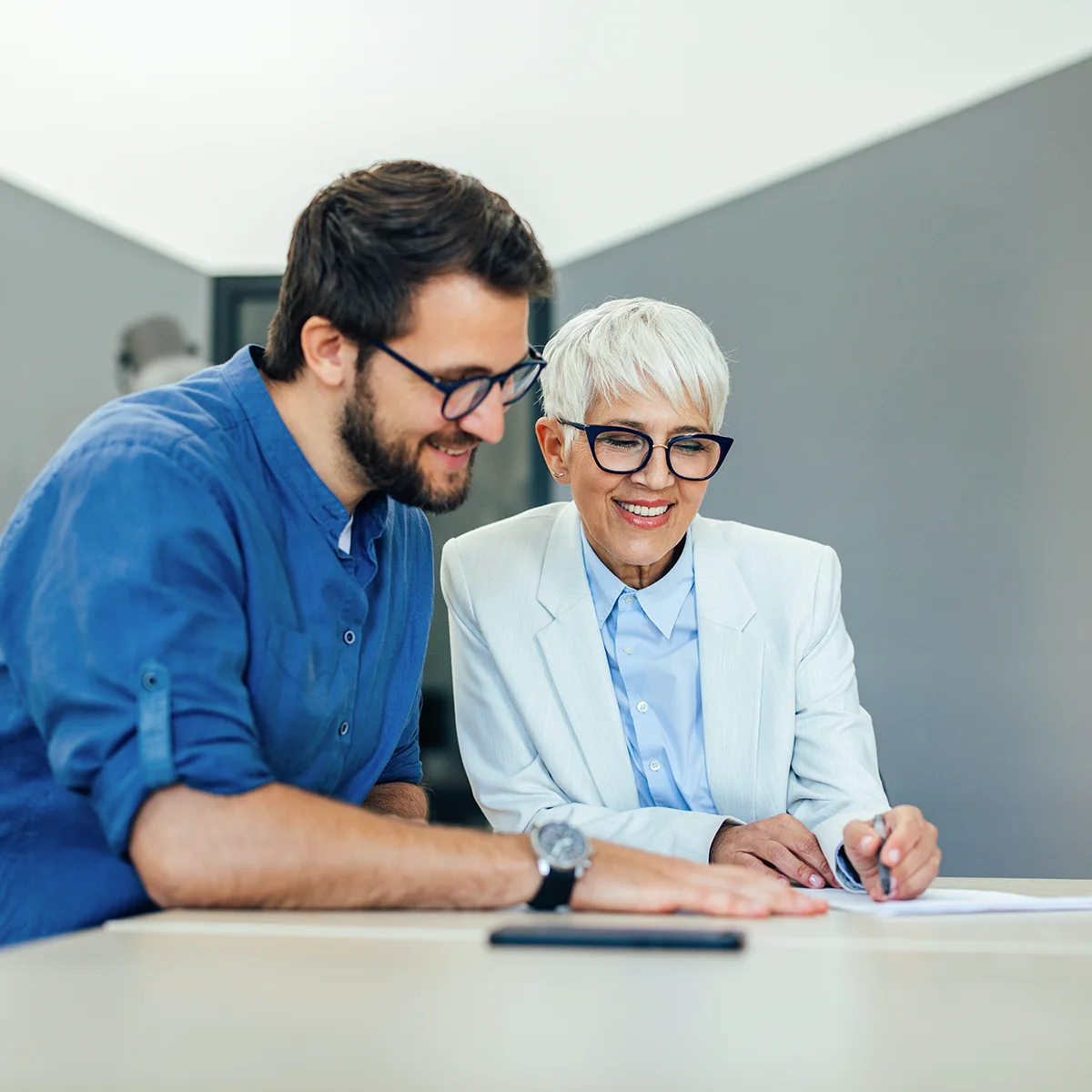 employer with new employee reviewing financial planning documents