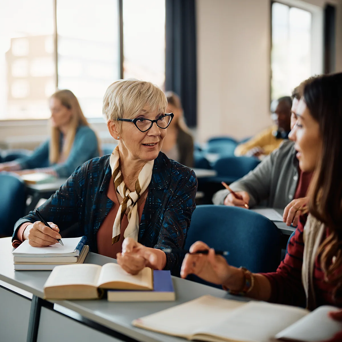 female college professor assisting student