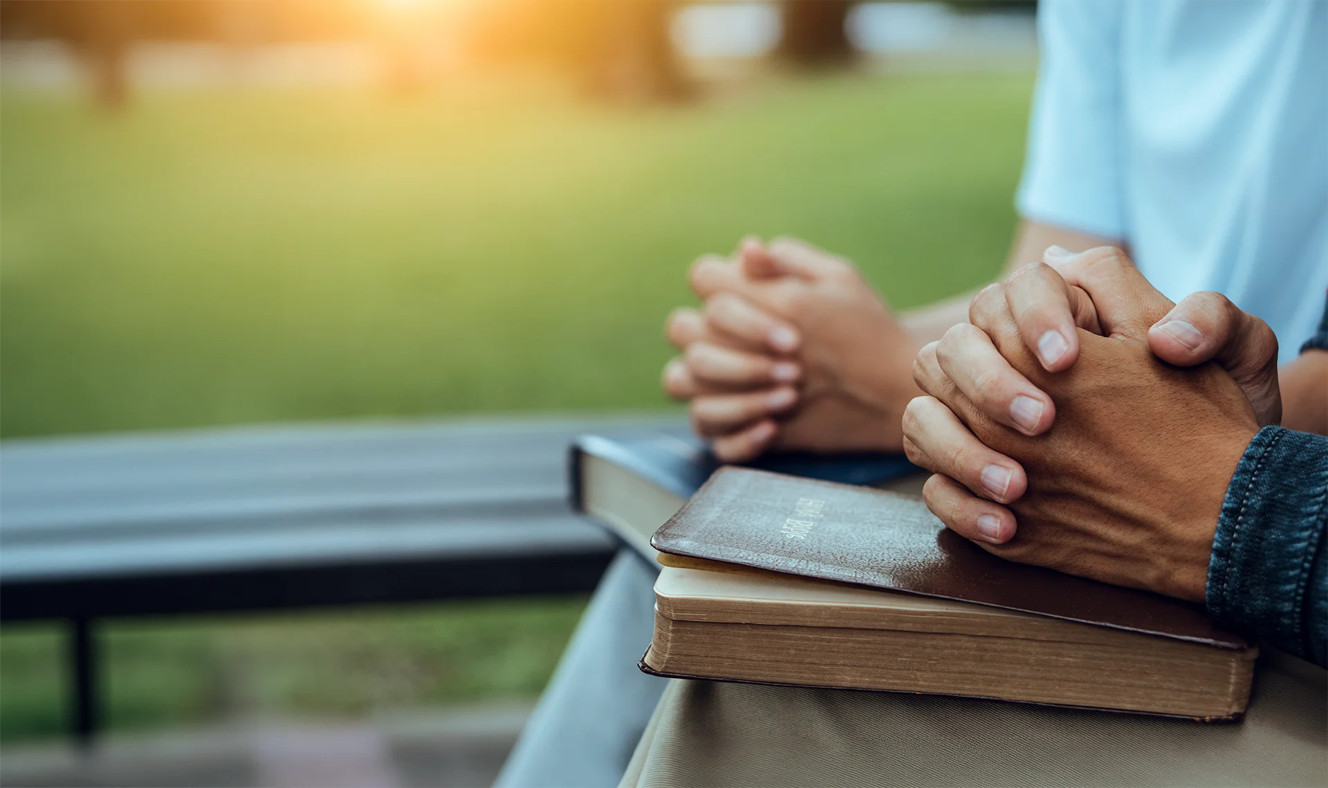 newly credentialed pastor praying with church member
