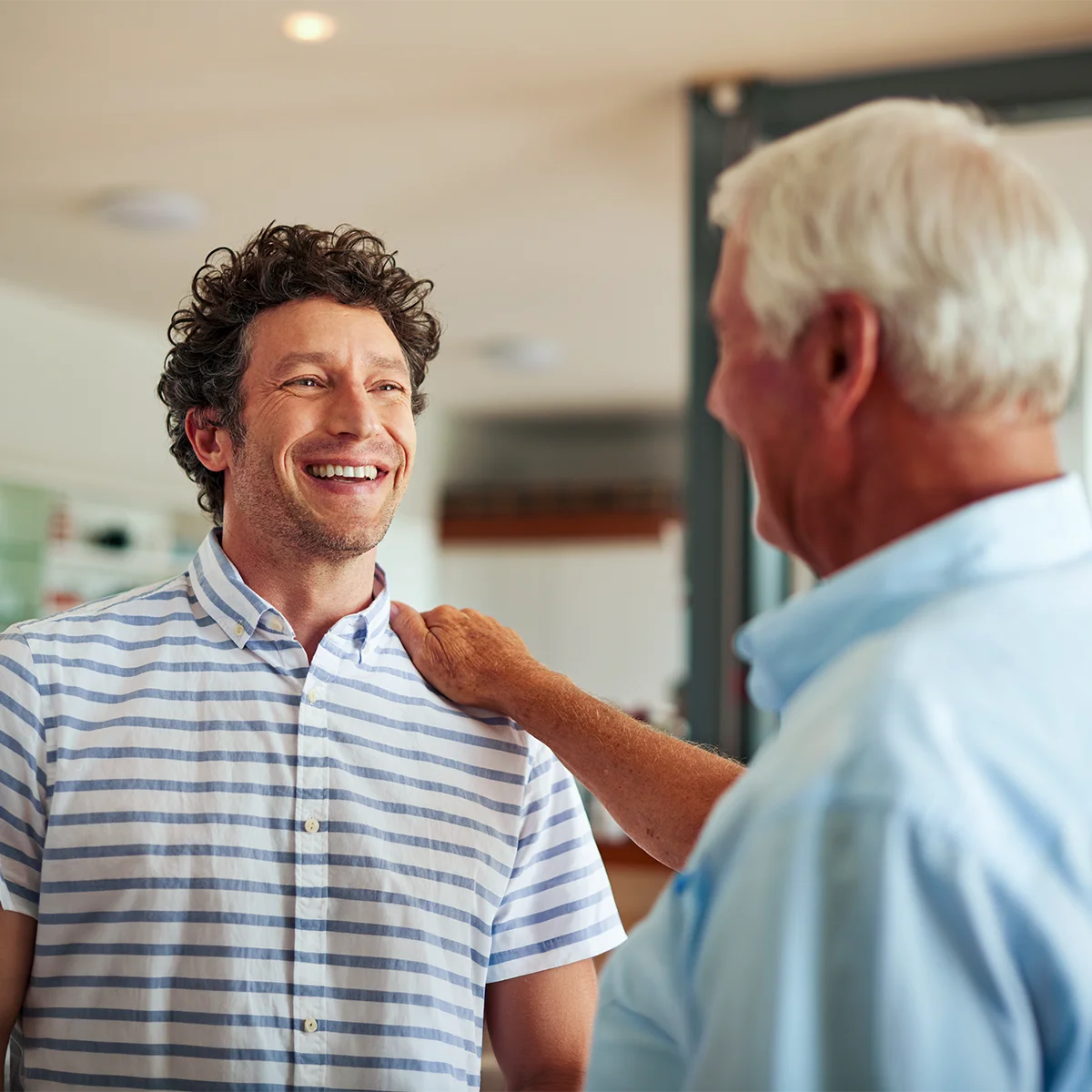 happy man being assisted by caring senior pastor