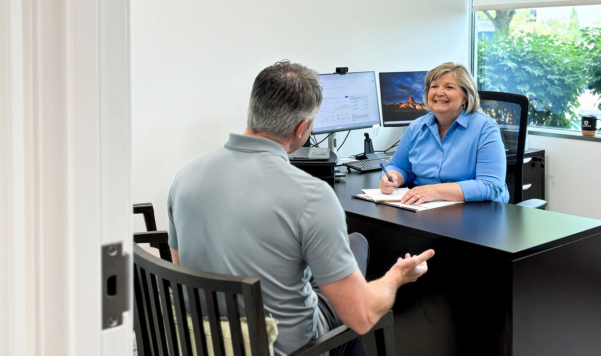 servant solutions director of member services meeting with client