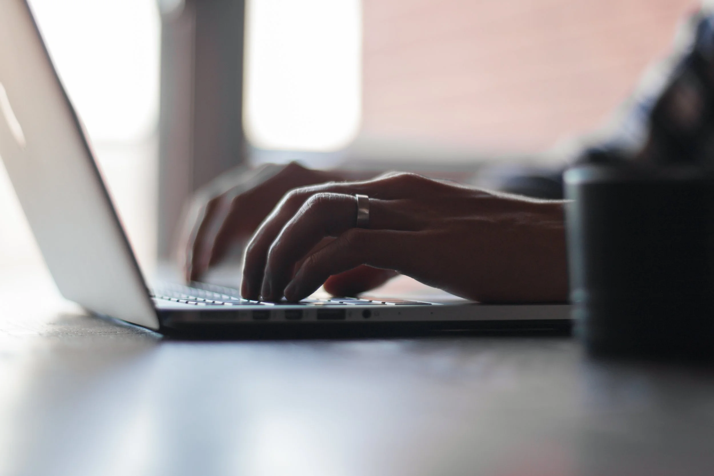 person typing on a laptop