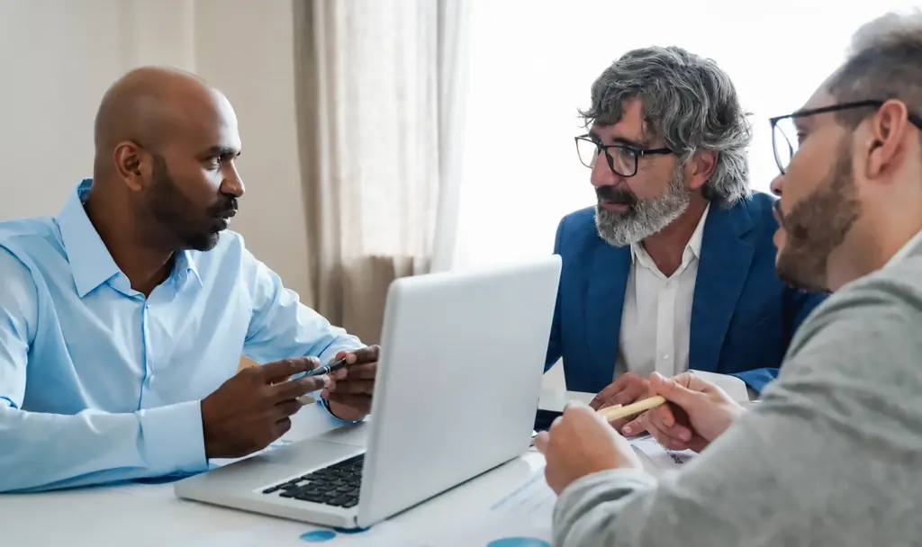 three ministry men talking business