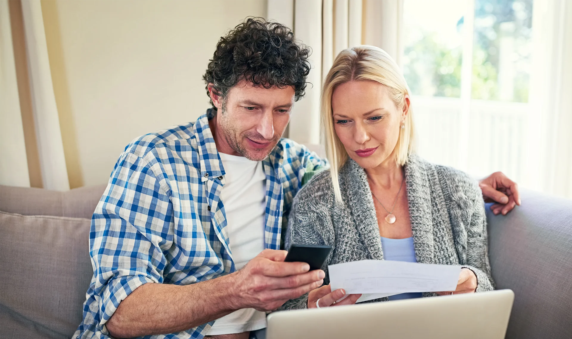 couple relaxing at home with technology