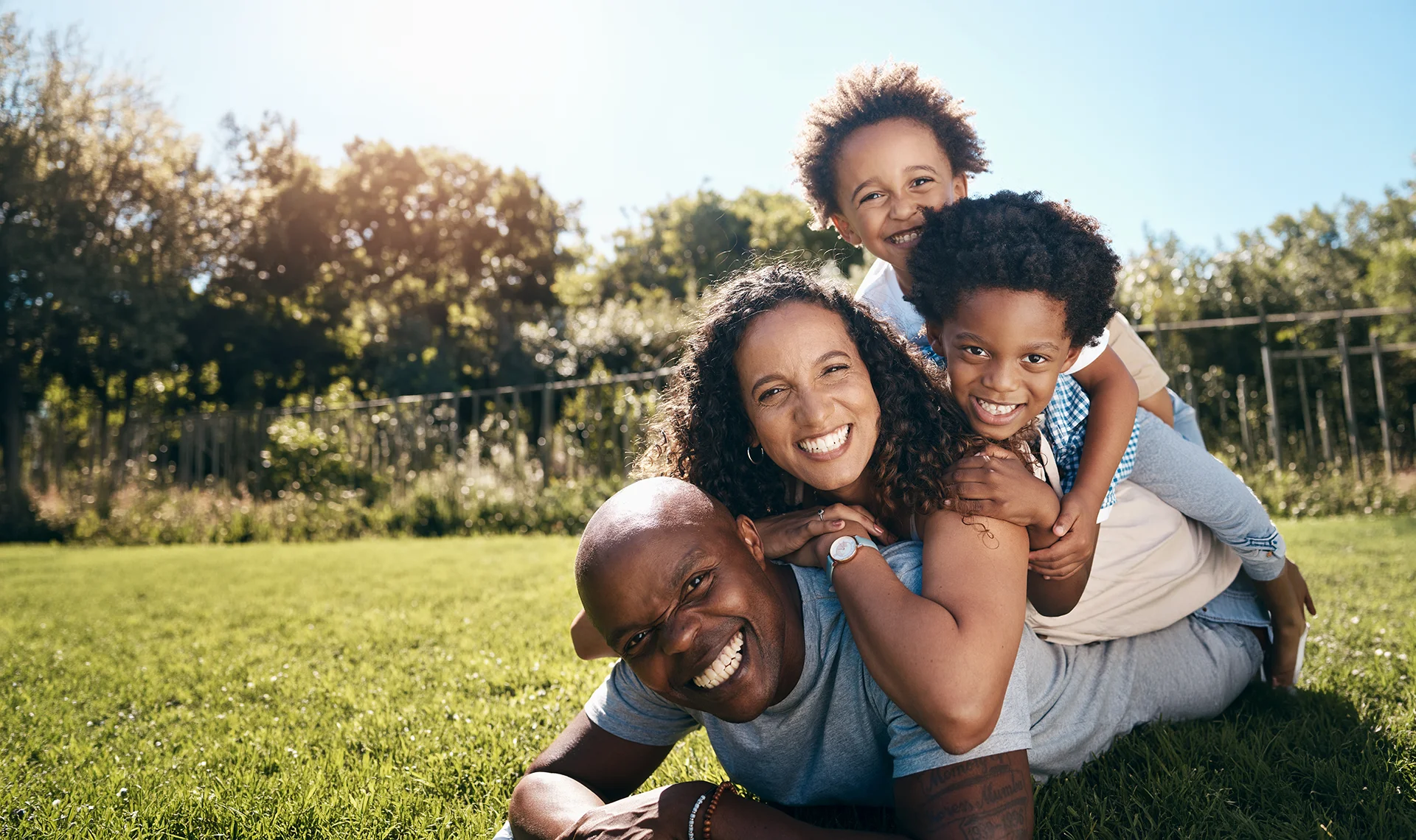 happy family smiling and laughing outside on grass