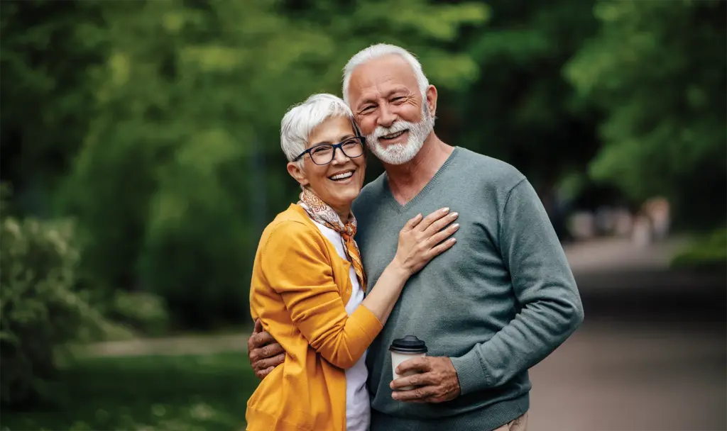 senior couple embracing while walking in the park